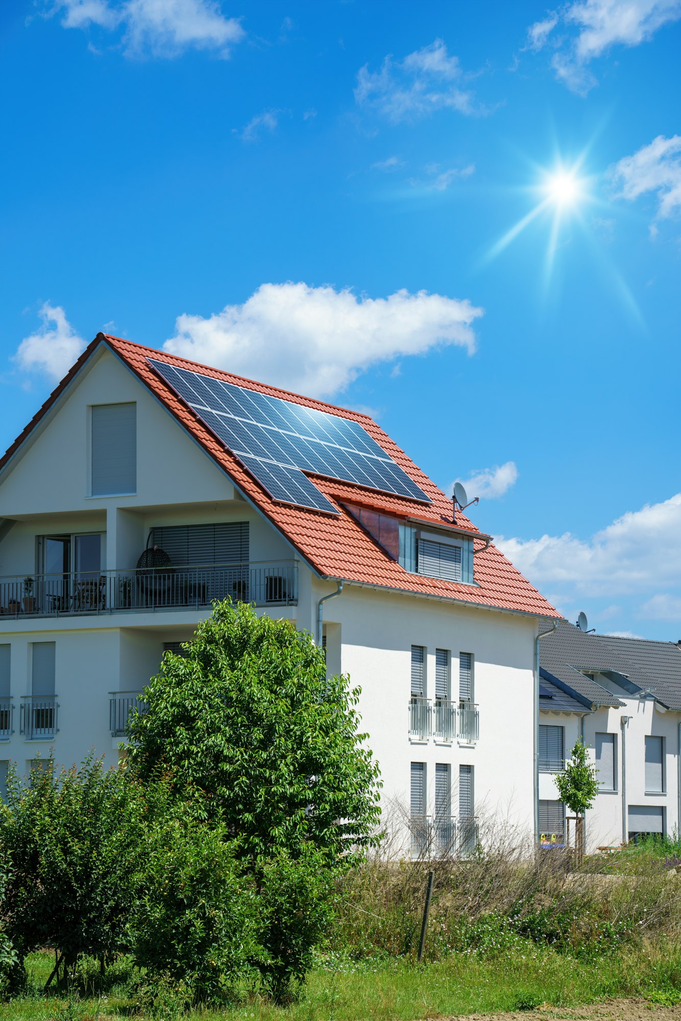 home with solar energy green plants and sunny blue sky